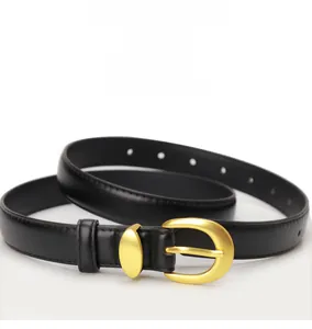 Close-up of black leather belt with a matte gold oval metal buckle and fine texture