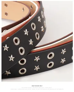 Detail of black punk belt with double rows of silver star rivets and metal eyelets