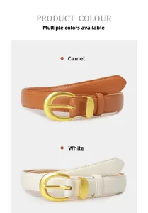 Detailed view of camel and white leather belts with matte gold circular buckles