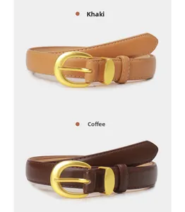 Detail of khaki and coffee faux leather belts featuring golden oval buckles and stitching