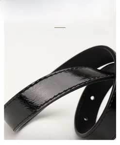 Close-up of black leather belt with fine stitching and polished finish details