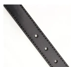 Close-up of black leather belt strap with refined stitching and three adjustment holes