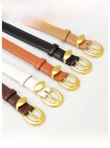 Detail of five women's leather belts in various colors with golden oval buckles