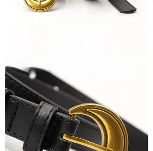 Detail of black leather belt with a vintage gold crescent buckle and fine edge stitching