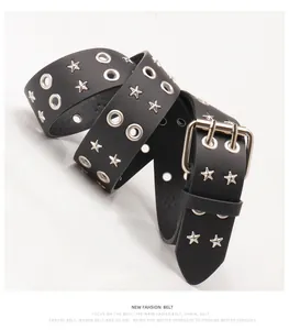 Detail view of black punk belt featuring silver star studs and double eyelet metal rings