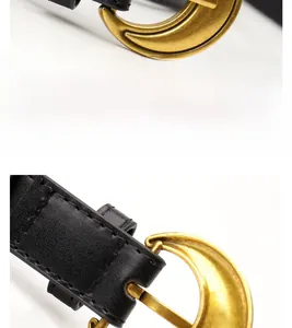 Close-up of vintage crescent moon alloy buckle on a black slim leather waist belt