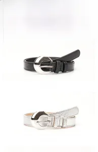 Detail showing black and silver slim waist belts with crescent moon metal buckles