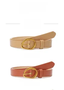 Detail of khaki and camel leather belts with irregular gold buckles and adjustable holes