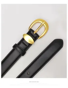 Detail of black leather ladies belt with gold horseshoe buckle and fine stitching