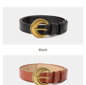 Detail of black and brown vintage crescent belts with golden buckles and fine stitching