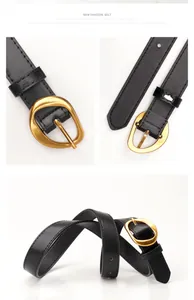 Detail of minimalist black leather belt with unique irregular gold metal buckle for women