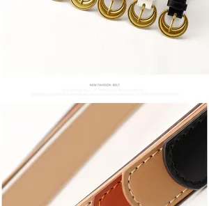 Detail of vintage gold crescent moon buckle and fine stitching on various leather belts