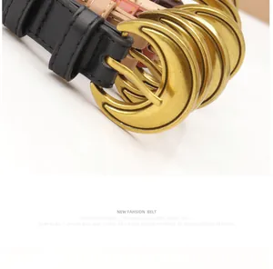 Detail of vintage gold half-moon buckle with matte finish on stylish leather belts