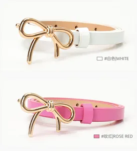 Detail of slim women belts with gold bow buckles in white and rose red colors
