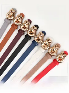 Detail of eight elegant women's skinny belts with gold knot buckles and litchi texture