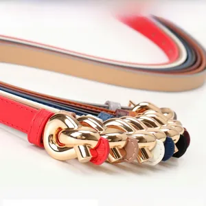 Detail of colorful women thin leather belts with elegant golden metal knot buckles