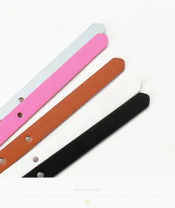 Detail of slim bow belts in five pastel colors with gold buckles and textured finish