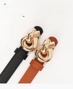 Detail of trendy women's belts with golden knot buckles in black and brown finishes