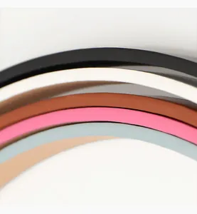 Close-up of premium leather bow belts showing multiple colors like beige, blue, and black