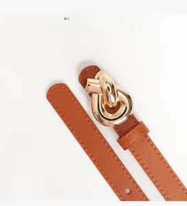 Close-up of brown leather belt featuring a unique gold knotted metal buckle and fine texture