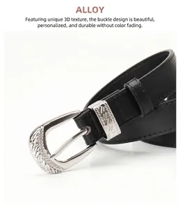 Detail of silver alloy buckle with engraved textures on a black leather belt