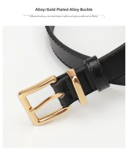 Close-up of black leather belt featuring a polished gold alloy rectangular buckle