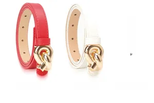 Detail view of fashion thin waist belts in red and white with gold knot buckles