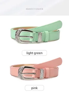 Detail of light green and pink thin belts with vintage engraved D-shaped silver buckles