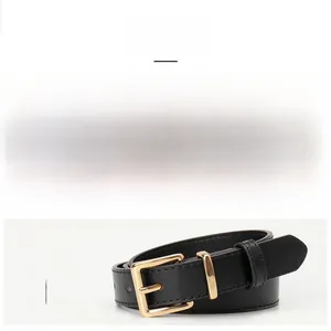 Detail of chic camel and black thin leather belts featuring elegant gold pin buckles