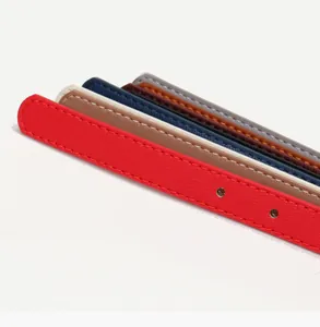 Detail of colorful faux leather belts showing stitched edges and metal-reinforced holes