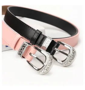Detailed close-up of silver vintage carved buckles on black and pink fashion leather belts