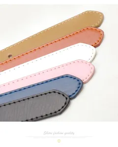 Detail of leather belt tips in multiple colors with fine stitching and smooth finish