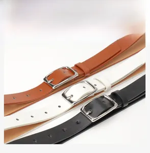 Detailed view of three slim leather belts in brown, white, and black with silver buckles