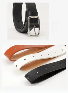 Detail of leather belts in black, white, and orange-brown with silver square buckles