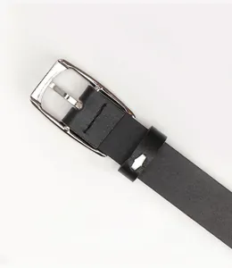 Close-up of the solid alloy buckle back on a classic black leather belt with fine texture