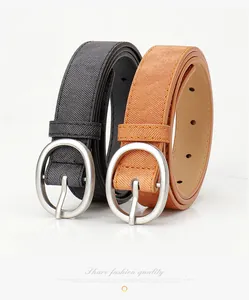 Detail of crosshatch texture and oval silver buckles on black and brown belts