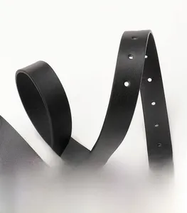 Close-up of black PU leather belt texture showing smooth grain and round pin buckle holes
