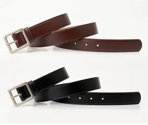 Detailed view of square metal buckles and stitching on black and brown leather belts