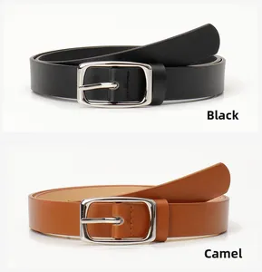 Close-up of black and camel leather belts with silver rectangular buckles and stitching