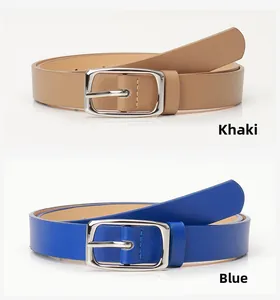 Detail of khaki and blue slim leather belts with polished silver pin buckles