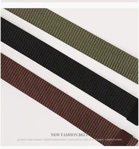 Detailed close-up of tactical nylon web belts in olive green, black, and dark brown