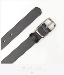 Close-up of minimalist black leather belt with silver polished metal buckle on white background