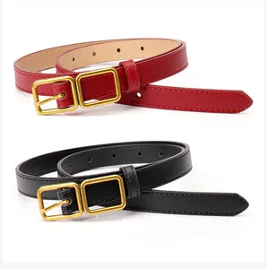 Close-up of black and red leather belts with elegant golden double square buckles