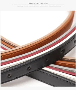 Macro shot of thin leather belts in multiple colors with fine stitching and silver buckles