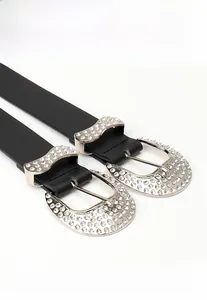 Detail of Y2K vintage black leather belt with silver horseshoe buckle and sparkling rhinestones