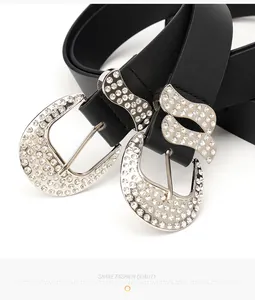 Close-up of Y2K vintage black leather belt with sparkling rhinestone wavy silver buckle