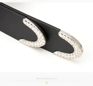 Macro shot of Y2K style black leather belt with sparkling rhinestones on silver buckle