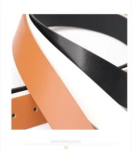 Macro detail of textured black and brown leather belts with precise edge finishing