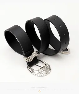 Close-up of black PU leather belt with rhinestone-studded buckle and buckle loop
