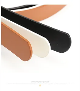 Detail view of multi-colored leather belts showing black, beige, and brown textures